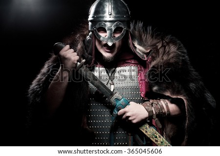 Screaming viking warrior with sword, armour and helmet over black background