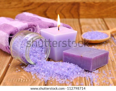 Purple sea salt and a burning candle