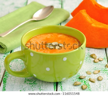 Pumpkin soup in a green bowl