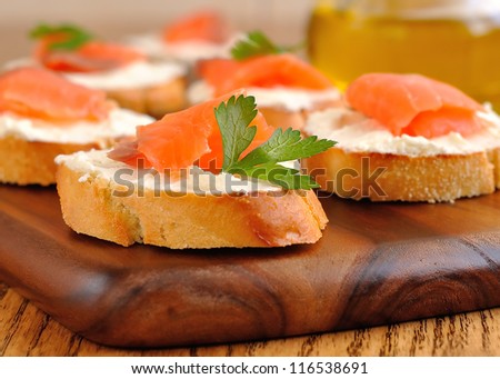 Sandwiches with a salmon on a brown table