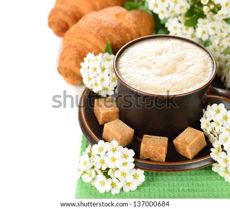 Cup of coffee and white flowers on a white background