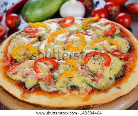 Vegetable pizza on a brown table