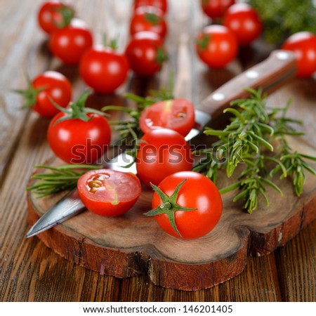 cherry tomatoes and rosemary on brown board