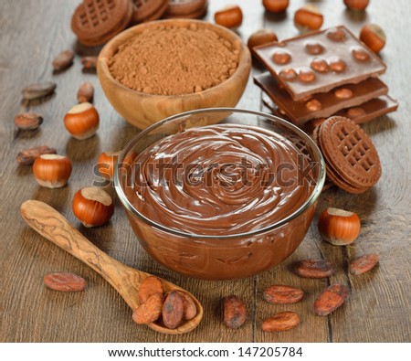 chocolate paste in a glass bowl on a brown table