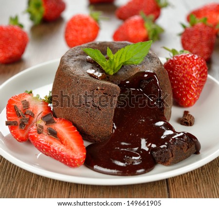 Cake with chocolate and strawberries on a brown background