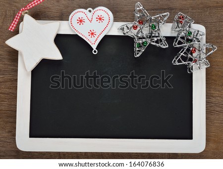 Writing board and Christmas decorations on a brown background