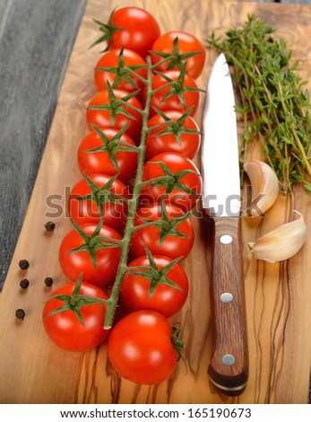 Fresh cherry tomatoes  on a brown board