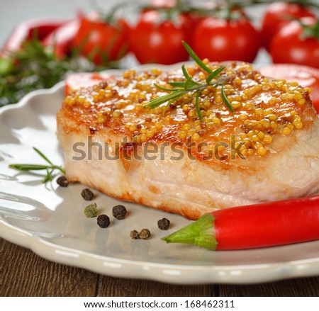 Fried meat with Dijon mustard on brown background