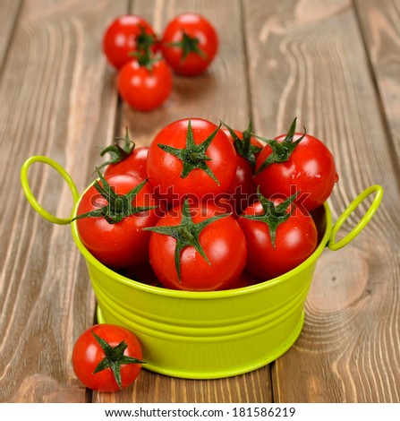 Fresh cherry tomatoes on a brown background