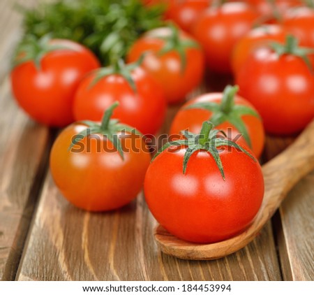 Fresh cherry tomatoes on a brown background