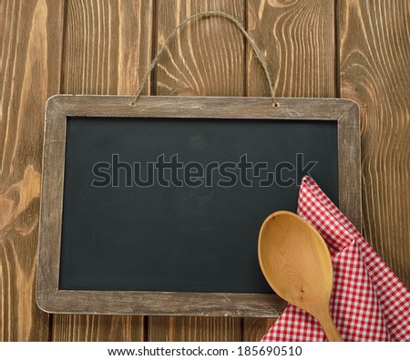 Writing board napkin and spoon on brown background