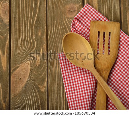 Wooden spoon and napkin on a brown background