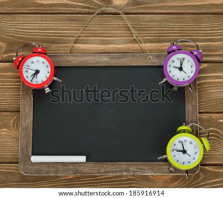 Writing board and clock on a brown background
