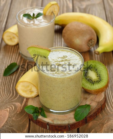 Smoothies of banana and kiwi on a brown background