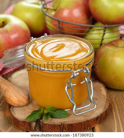 apple sauce in a jar on a brown background