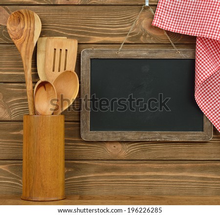 Writing board and spoons on brown background