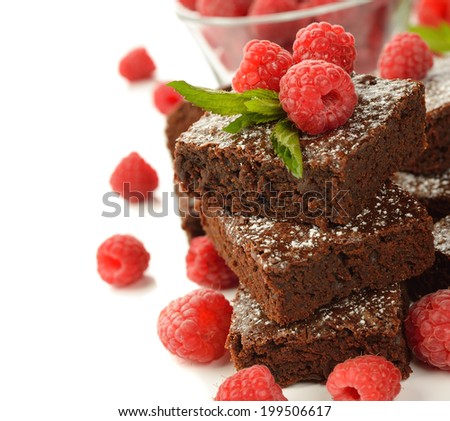 Chocolate brownies with raspberries on white background