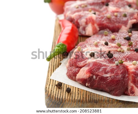 Raw meat with spices on a white background