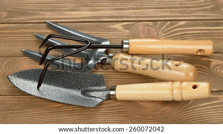 Garden tools on brown background