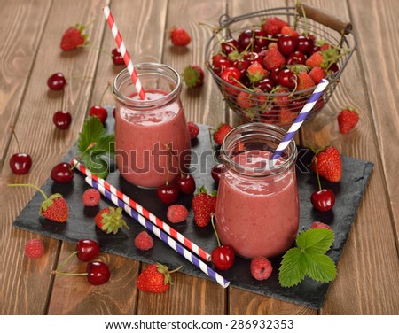 Berry smoothie on brown background