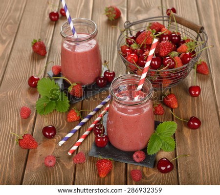 Berry smoothie on brown background