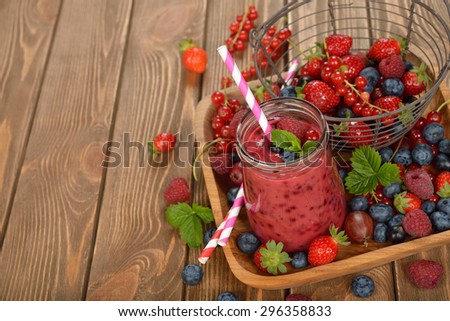 Smoothies with fresh berries on a brown background