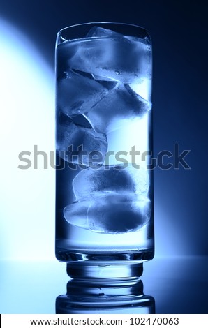 glass of water spot light blue with ice