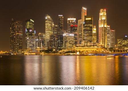 SINGAPORE - AUGUST 5_Business buildings shining beams of light at night time around Marina Bay on August 5, 2014 in Singapore