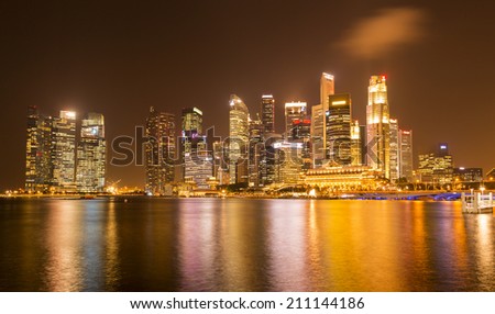 SINGAPORE - AUGUST 5_Business buildings shining beams of light at night time around Marina Bay on August 5, 2014 in Singapore