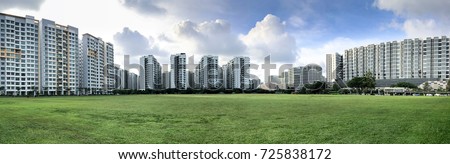 Panoramic view of Singapore Public Housing Apartments in Punggol District, Singapore. Housing Development Board(HDB) on green grass field