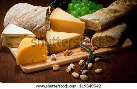 Various types of cheese with bread and fruit