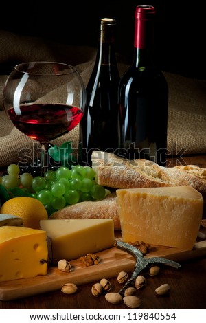 Red wine with cheeses, bread and fruits