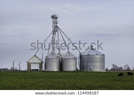 A set of silos in a farm field.