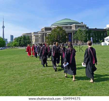 TORONTO - JUNE 8, 2012:  Law graduates of the University of Toronto walk towards Convocation Hall to receive their diplomas on June 8, 2012 in Toronto.   Half the graduating class consists of women.