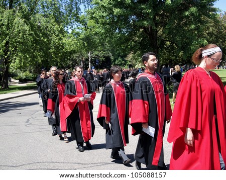 TORONTO - JUNE 8:  Graduates of the University of Toronto walk to receive their diplomas on June 8, 2010 in Toronto.   The red hoods signify recipients of doctoral degrees.