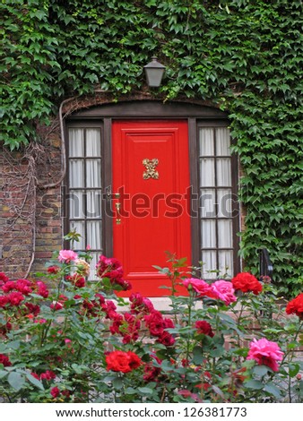 red front door with roses and ivy