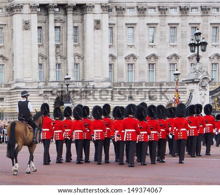 LONDON - AUGUST 2:  The changing of the guard ceremony at Buckingham Palace with soldiers wearing the traditional red coats and fur hats, as seen on August 2, 2013.