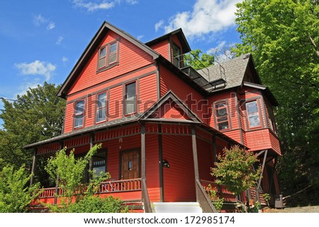 red house with large porch