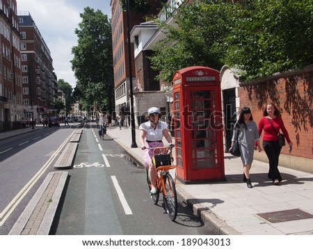 LONDON - JULY 29, 2013:  A completely separated bike lane is safer and encourages more bicycle commuting in London.