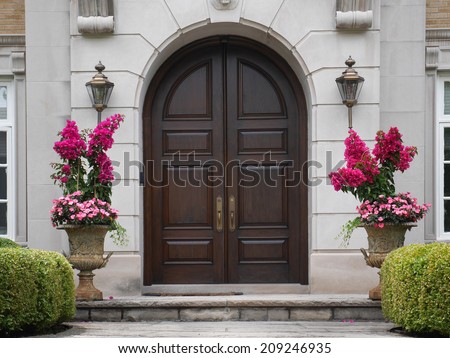 wooden double doors with flower pots