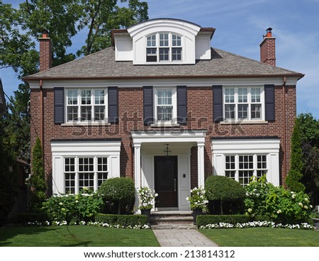 Traditional two story brick house with dormer window