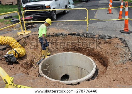 BOSTON - JUNE 2014:  A middle aged man works on a road repair crew, as older skilled workers are an important part of the work force as seen in Boston in 2014.