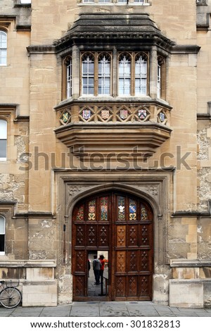 OXFORD, ENGLAND - JULY 2013:  Oriel College\'s ornate main gate has a small wicket door built into it which is used  for ordinary entry by students,  as seen in Oxford in July 2013.