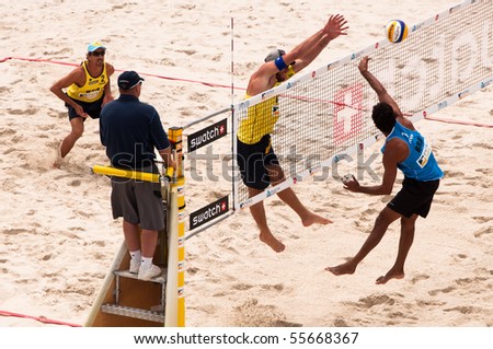 PRAGUE - JUNE 19: Benjamin Insfran spikes, Alison Cerutti blocks and Emanuel Rego is waiting for the ball at SWATCH FIVB World Tour 2010  June 19, 2010 Prague