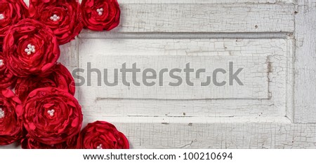 Red shabby chic flowers on vintage door