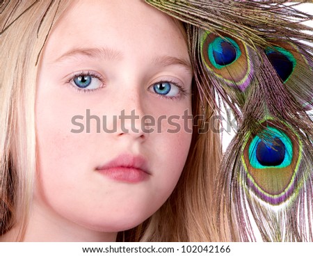 Beautiful Girl with Peacock Feather head dress, close-up isolated on white