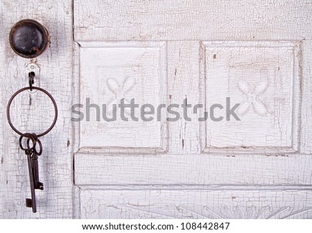 Vintage key unlocking an  old cracked antique or vintage door