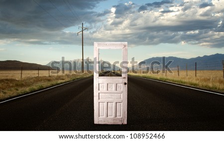A roadway with a vintage door in the middle of the road,