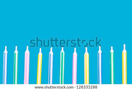 Birthday candles in a row on a blue background