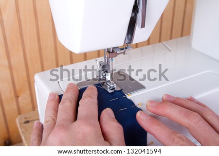 Sewing blue fabric on sewing machine